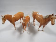Three Beswick palomino horses to include a swish tail example