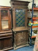 A Victorian oak glazed and leaded carved cupboard with lion mask detail H 235 cm W 92 cm