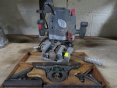 A woodwork plunge router and a boxed carpenters angle measure tool