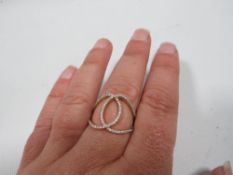 A designer interlocking loop diamond ring set with approx quarter carat diamonds and stamped 9k