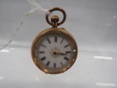 A small 14c gold cased fob watch with decorative enamel dial and chased engraving