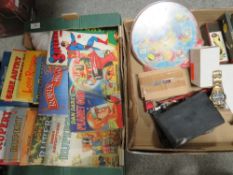 Two trays of vintage games and annuals to include a vintage Dan Dare planet gun in original box