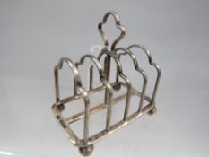 A hallmarked silver four division toast rack