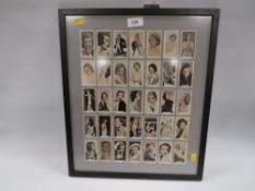 A framed and double sided glazed cigarette cards 'Stage and screen beauties' by Godfrey Phillips