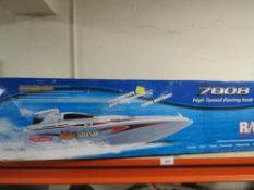 A radio controlled 7008 hi-speed racing boat - untested, together with an Aston Martin remote