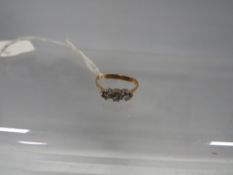 A three stone diamond ring on unmarked yellow metal A/F approx weight 1.6 g
