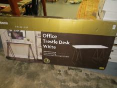 A boxed office trestle desk in white