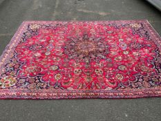 A large Eastern woollen rug 307 x 220 cm