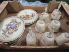 A tray of Goebel year plates together with seven Goebel year bells