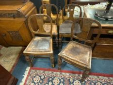 A set of four carved oak dining chairs. S/D