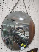 A circular vintage scalloped edge wall mirror