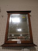 A oak framed bevelled edged wall mirror