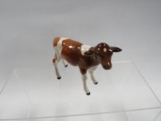 A Beswick Ayrshire calf - small chip to back of right ear