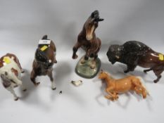 A Beswick bison together with four damaged Beswick horses to include skewbald pony - having