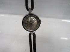 A small circular Omega wristwatch on leather strap