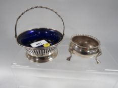 A hallmarked silver swing handled pierced basket with blue liner together with a hallmarked silver