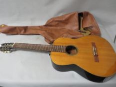 A vintage acoustic guitar with case