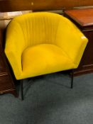 A modern showhome yellow upholstered tub chair