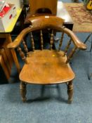 An antique elm smokers bow armchair
