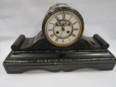 A marble and black slate drum head mantle clock with visible escapement