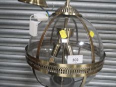 A modern gilt metal and glass globe ceiling light