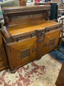 A heavy carved oak sideboard W 150 cm