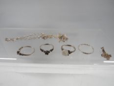 Four silver rings, silver bracelet etc.