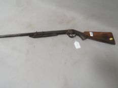 An antique air rifle with chequered grip