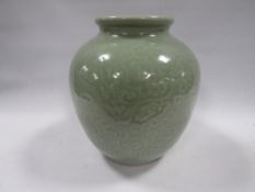 A Chinese celadon glazed three toed dragon vase