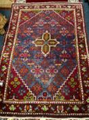 An Eastern red woollen rug 150 x 105 cm