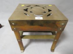 A vintage brass butler / trivet stand