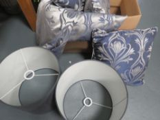 Two faux indoor pot plants together with cushions, curtains and lamp shades