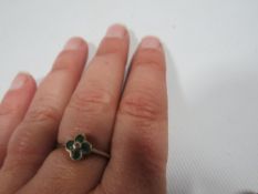 A hallmarked 9 carat gold ring set with emeralds in a four leaf clover setting approx. weight 1.5g