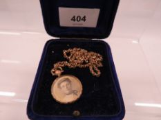 A Victorian 9ct gold double sided locket on rolled gold chain