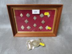A FRAME OF SCOTTISH REGIMENTAL BUTTONS, along with a Victorian volunteers buckle