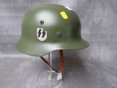 A REFURBISHED WW2 GERMAN STEEL HELMET, original repainted shell with replacement chin strap and