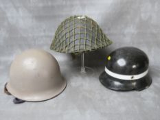 A BRITISH TURTLE TYPE TIN HELMET, (1952 by Rubry Owen), together with a French helmet dated 1964 (