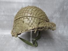 A US ARMY VIETNAM ERA TIN HELMET AND LINER