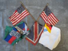 A COLLECTION OF FLAGS, to include a small Union Jack. 2 x US flags (48 stars), a Soviet / GDR type