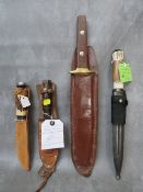A COLLECTION OF VARIOUS KNIVES, to include a US pilot survival type, a Bowie style in leather