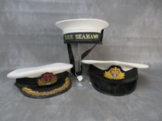 THREE ROYAL NAVY CAPS, consisting of two officers types with Queens crown badges and a seaman's with