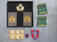 A GROUP OF CONTROL COMMISSION GERMANY INTEREST, consisting of slips x 2, enamel shield badge, sleeve