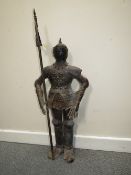 A DECORATIVE METAL FIGURE OF A STANDING KNIGHT IN ARMOUR HOLDING A POLE ARM, H 89 cm