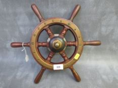 A SMALL VINTAGE MAHOGNAY AND BRASS BOAT WHEEL