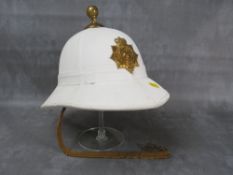 A ROYAL MARINES BANDSMAN HELMET, white finish with brass furniture