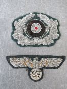 A WW2 GERMAN BULLION BREAST EAGLE, and a bullion hat cockade (2) on dark green ground
