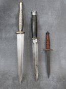 A COMMANDO STYLE KNIFE, with silver coloured ribbed grip, a sample size fishtail knife and one other