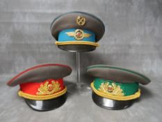 THREE EAST GERMAN (GDR) OFFICERS CAPS, with gilt badges and bullion thread type bands (3)