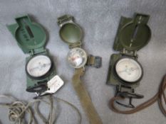 A US WRIST COMPASS DATED 1952, plus two marching compasses dated 1979 and 1986 (3)