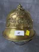 A VINTAGE FRENCH BRASS FIRE HELMET, the badge inscribed 'SAPEURS POMPIERS DE BOIGNY'